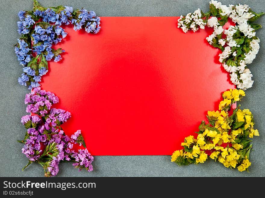 Red paper blank on grey background with flowers design