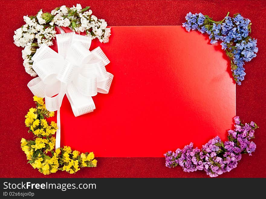 Greeting card with white bow and flowers on red. Greeting card with white bow and flowers on red