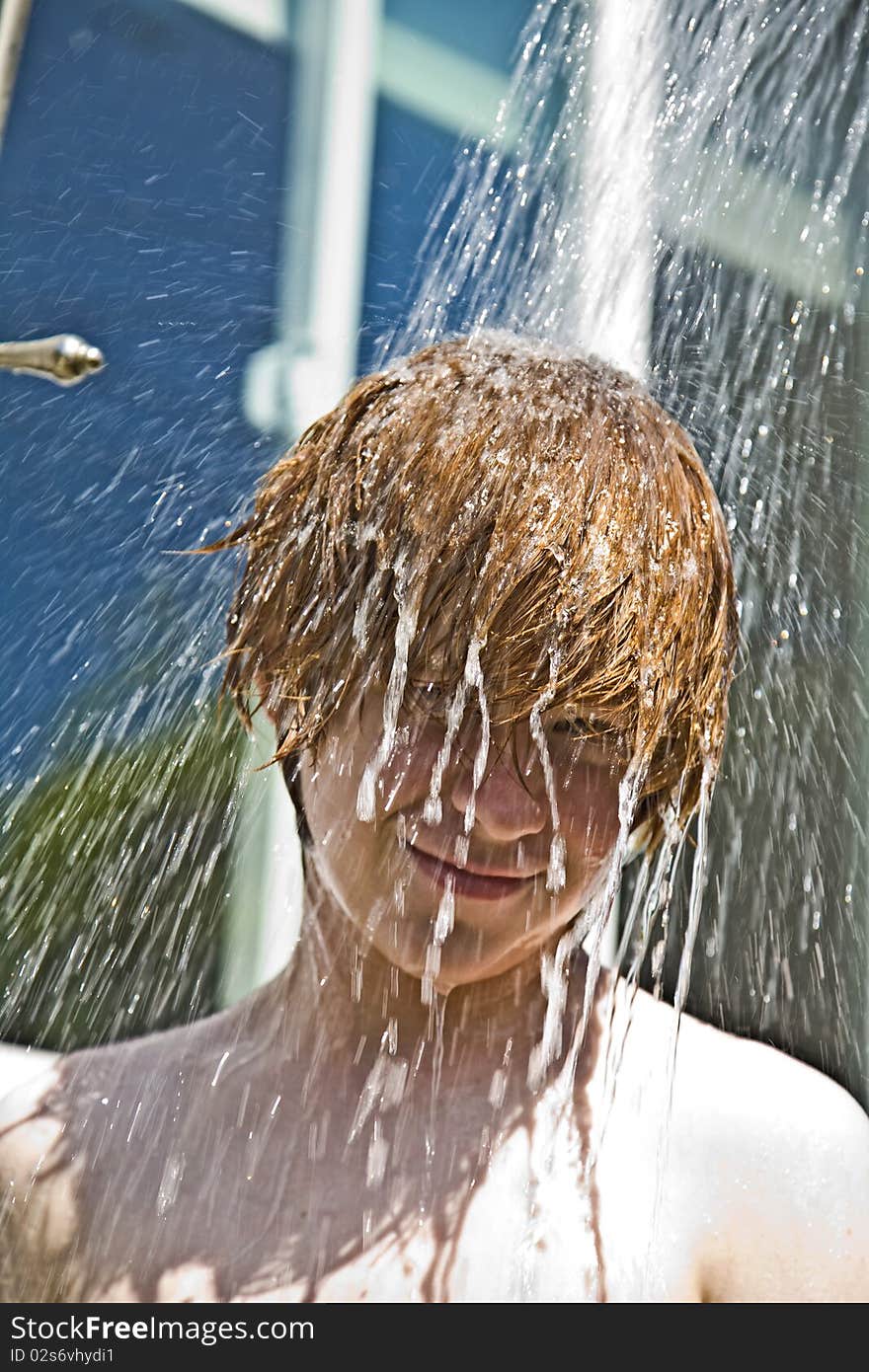 Child has a refreshing shower in the heat