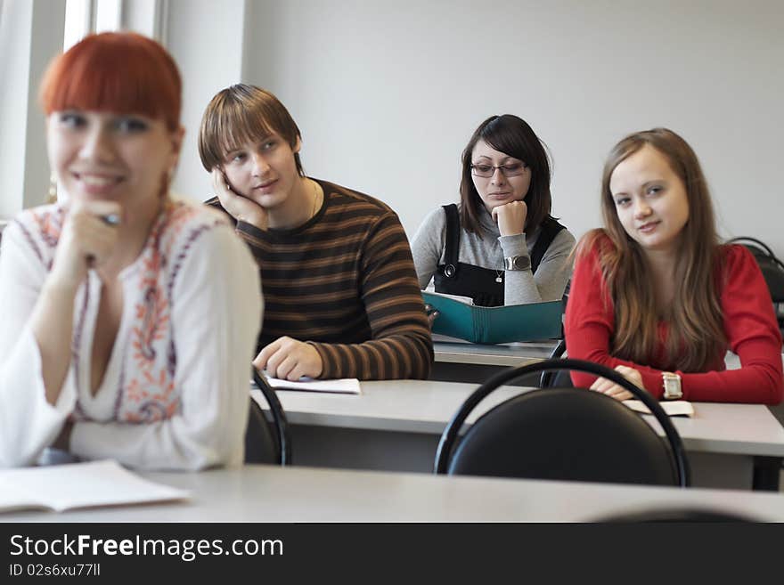 The students on employment sits at a table indoors