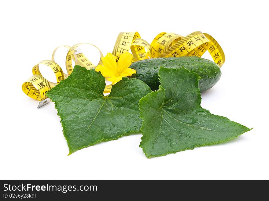 Cucumber with a measuring tape on white