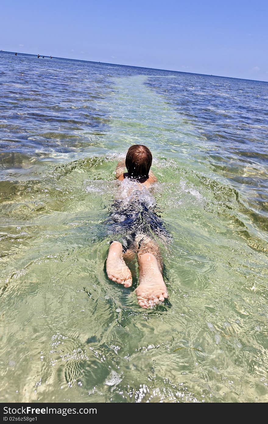 Boy enjoys the clear ocean