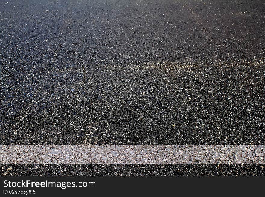 Road asphalted with a white dividing strip abstract background. Road asphalted with a white dividing strip abstract background