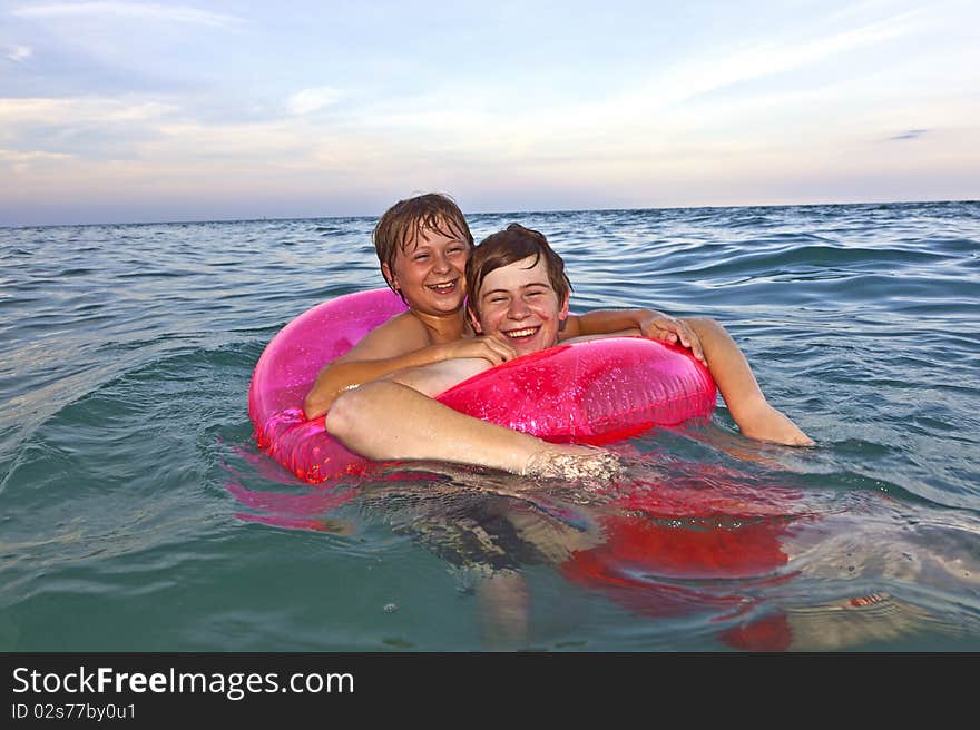 Brothers In A Swim Ring Have Fun In The Ocean