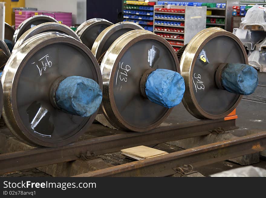 Spare railway wheels on the axle in a repair workshop