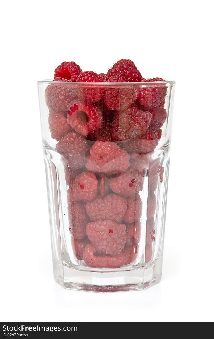 Glass full of fresh delicious raspberries