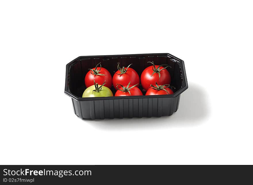 Organic red and green tomato in container