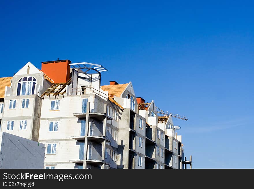 Construction site over summer blue sky, building growth. Construction site over summer blue sky, building growth