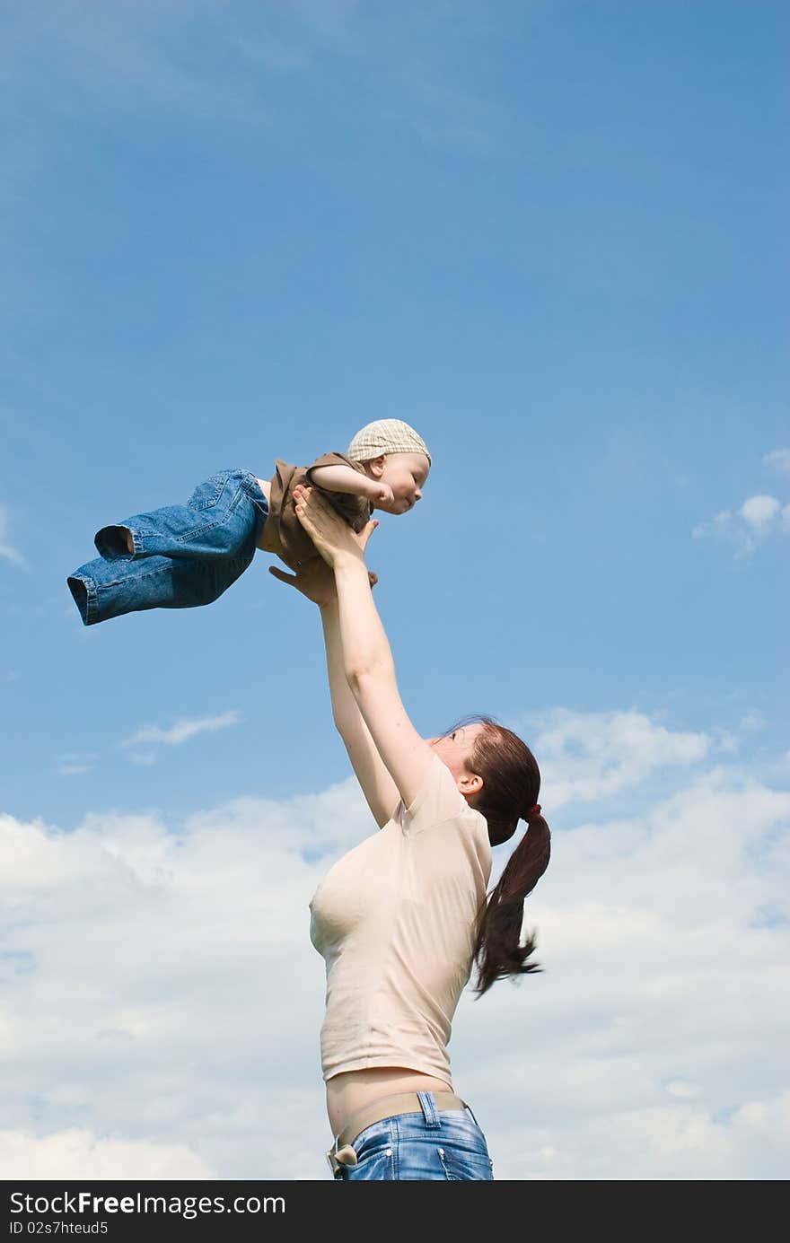 Mother playing with baby in the sky