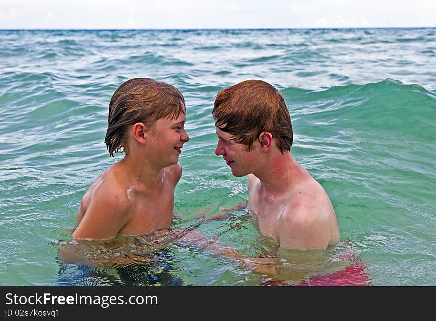 Boys Having Fun In The Clear Sea