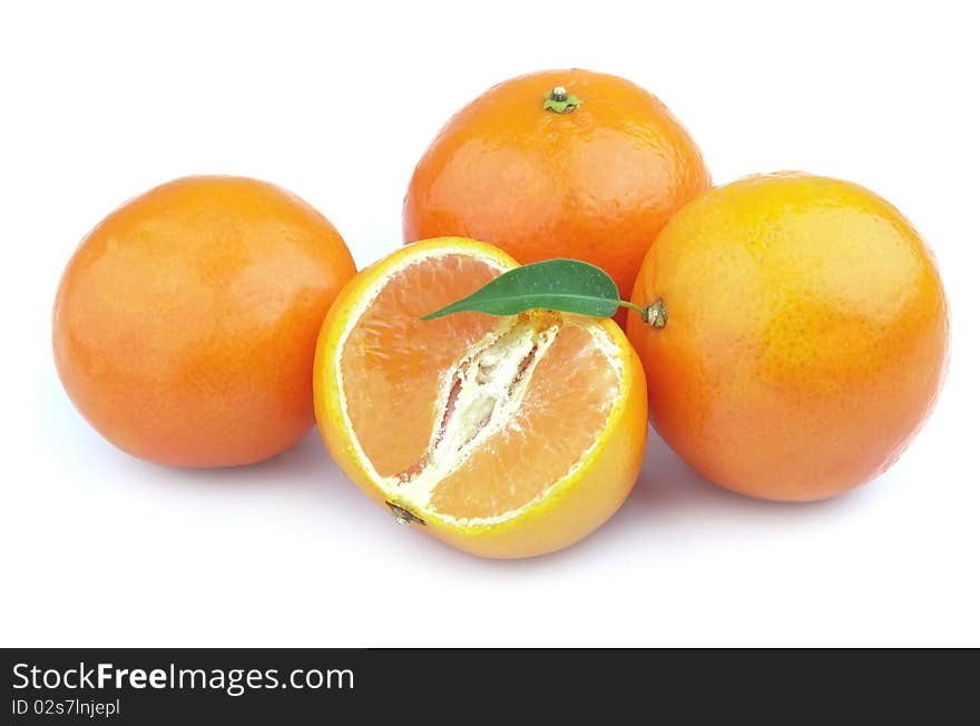 Tangerines entirely and segments and with leaves close up. Tangerines entirely and segments and with leaves close up