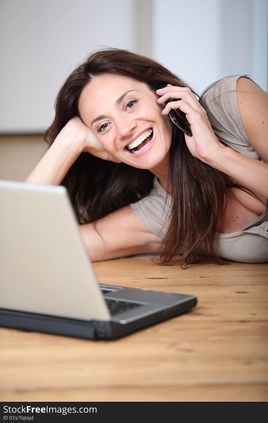 Woman talking on mobile phone at home. Woman talking on mobile phone at home