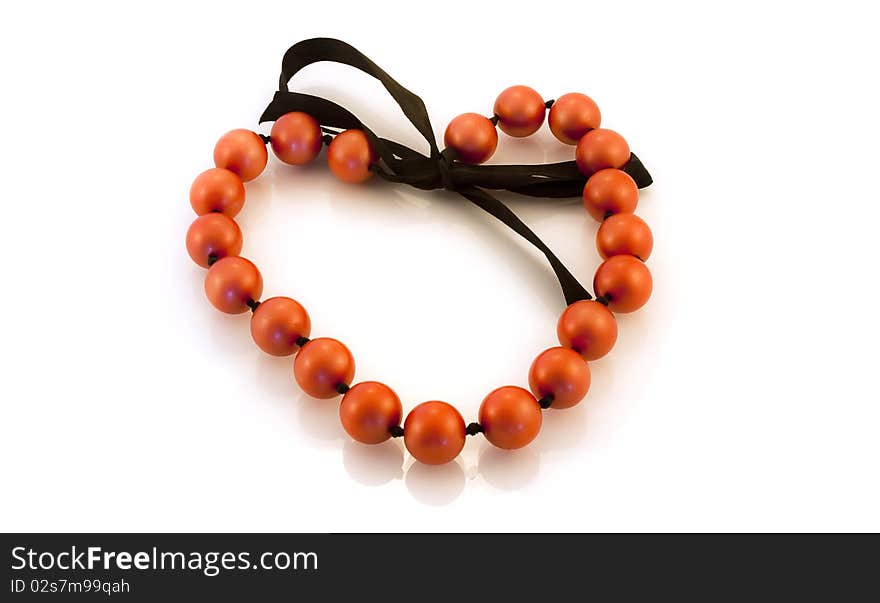 Beads in the shape of a heart on a white background