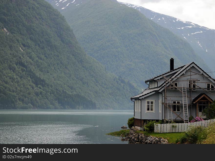 The village of Mundal on Fjaerlandsfjord with its houses along the shore. The village of Mundal on Fjaerlandsfjord with its houses along the shore