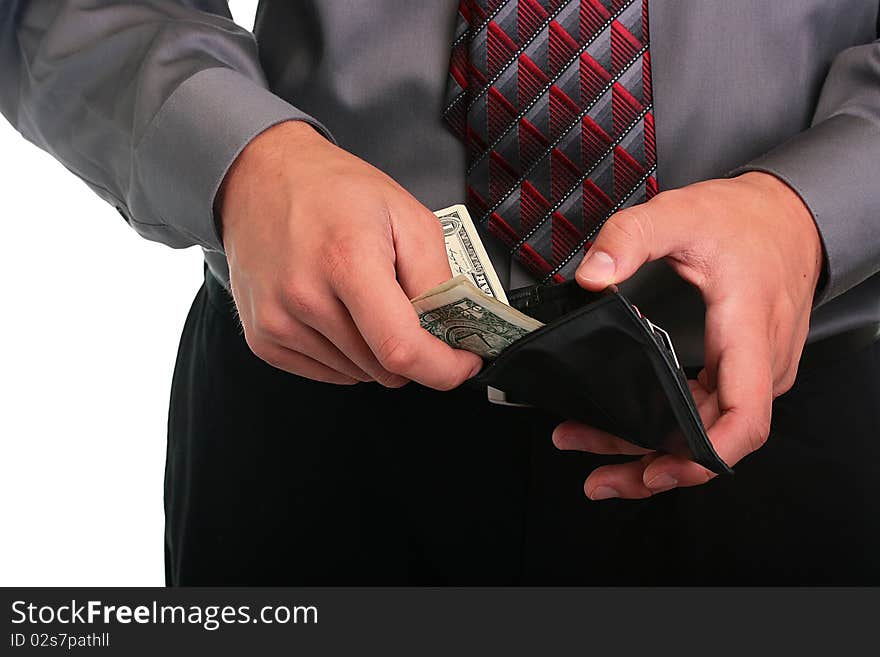 The businessman in a grey shirt and a tie hides money in a purse. The businessman in a grey shirt and a tie hides money in a purse.