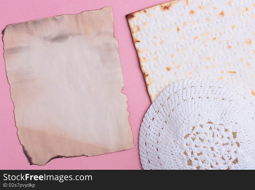 Jewish symbols laying next to an old piece of paper. Add your text to the paper.