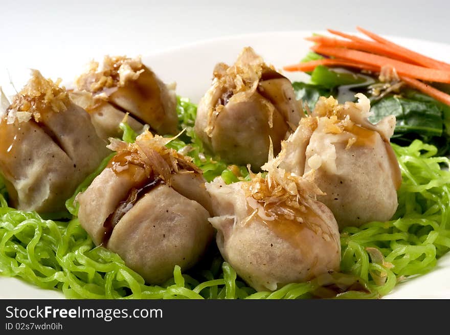 Noodle with pork meat ball on white plate