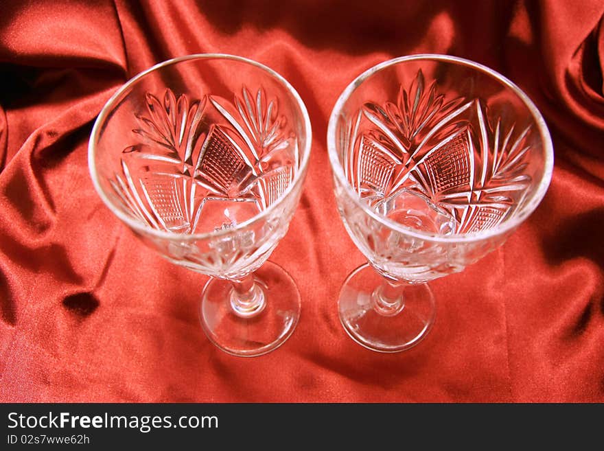 Two glasses on the red cloth background