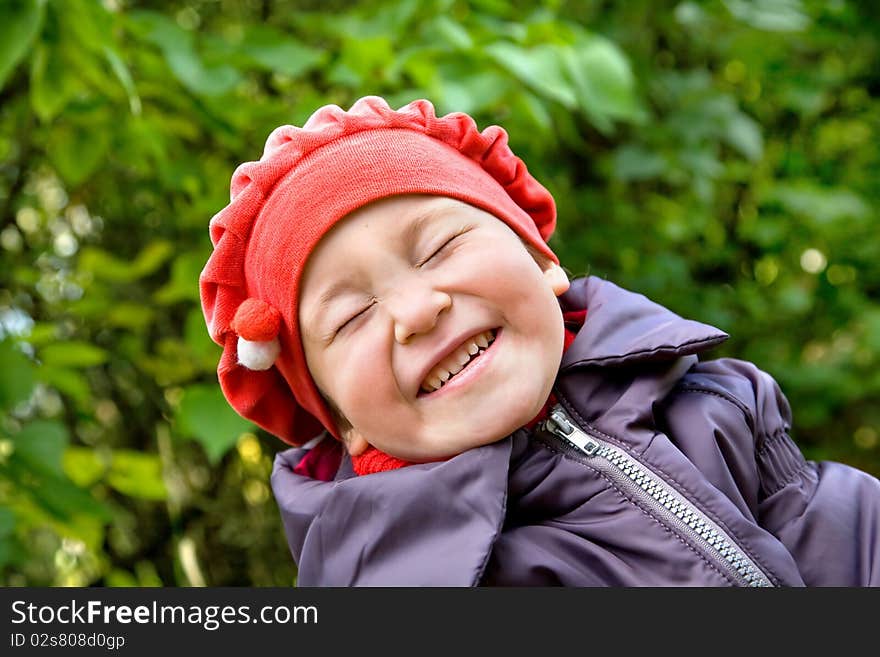 Portrait of laughing little girl in the park