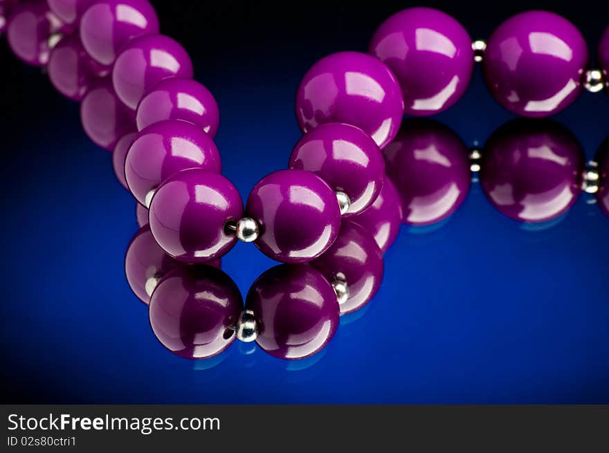 Purple pearls with blue background