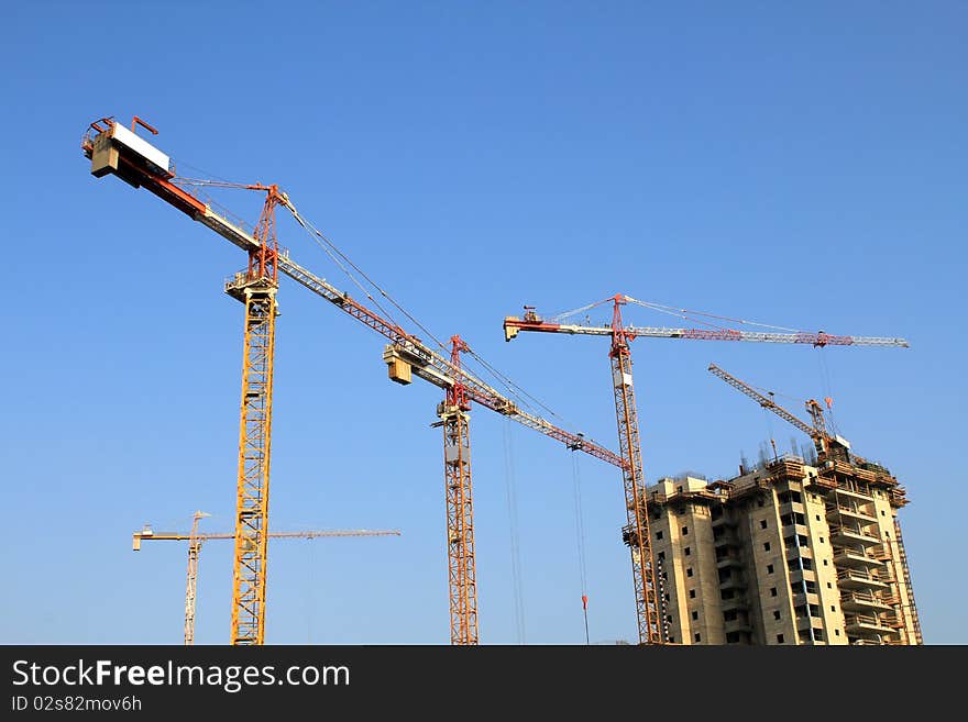 Cranes against a background of blue sky