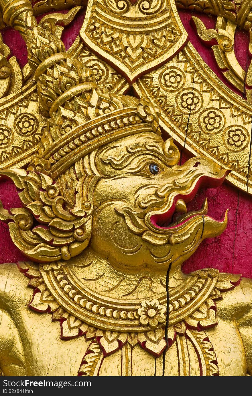 Garuda carved gold paint on church door. Garuda carved gold paint on church door