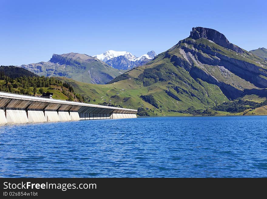 Lake and weir in alpine mountain in France on summer