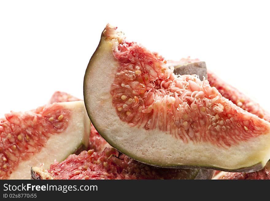 Sliced figs on top of each other against a white isolated background.