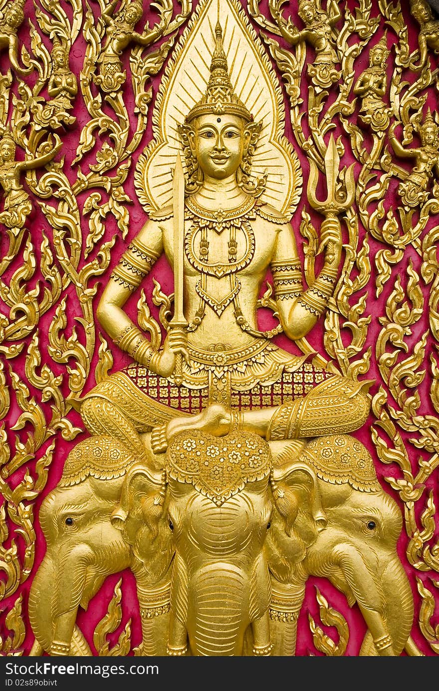 Buddha carved gold paint on church door. Buddha carved gold paint on church door