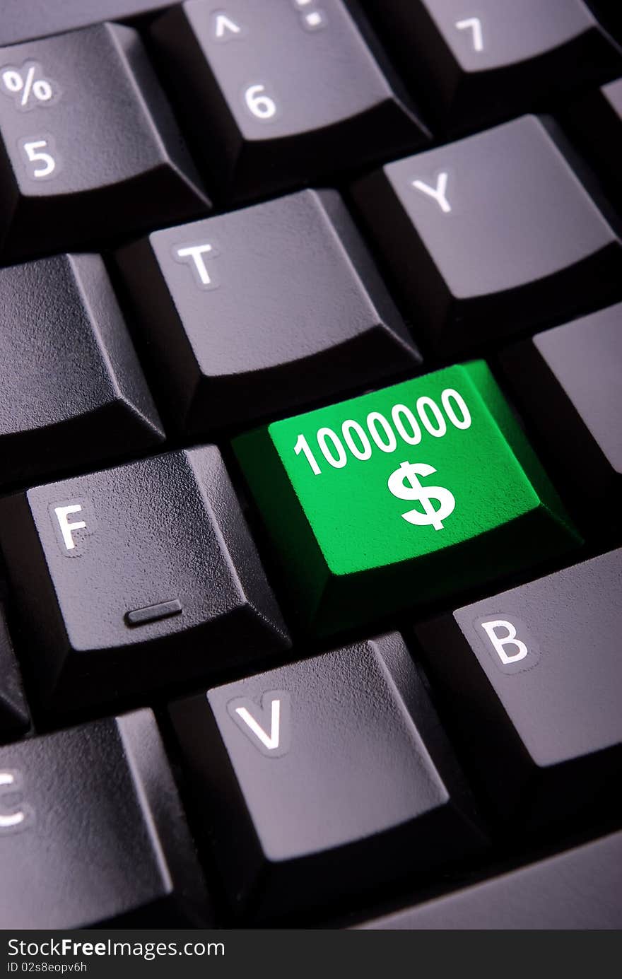 Sign of million dollars on a close-up computer button. Sign of million dollars on a close-up computer button