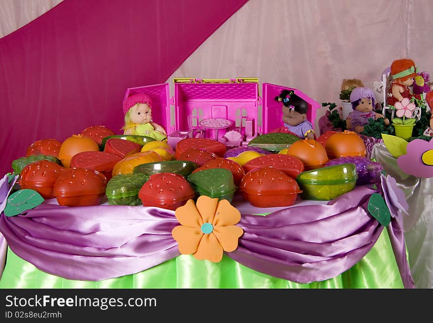 Decorated table with dolls and other toys. Decorated table with dolls and other toys