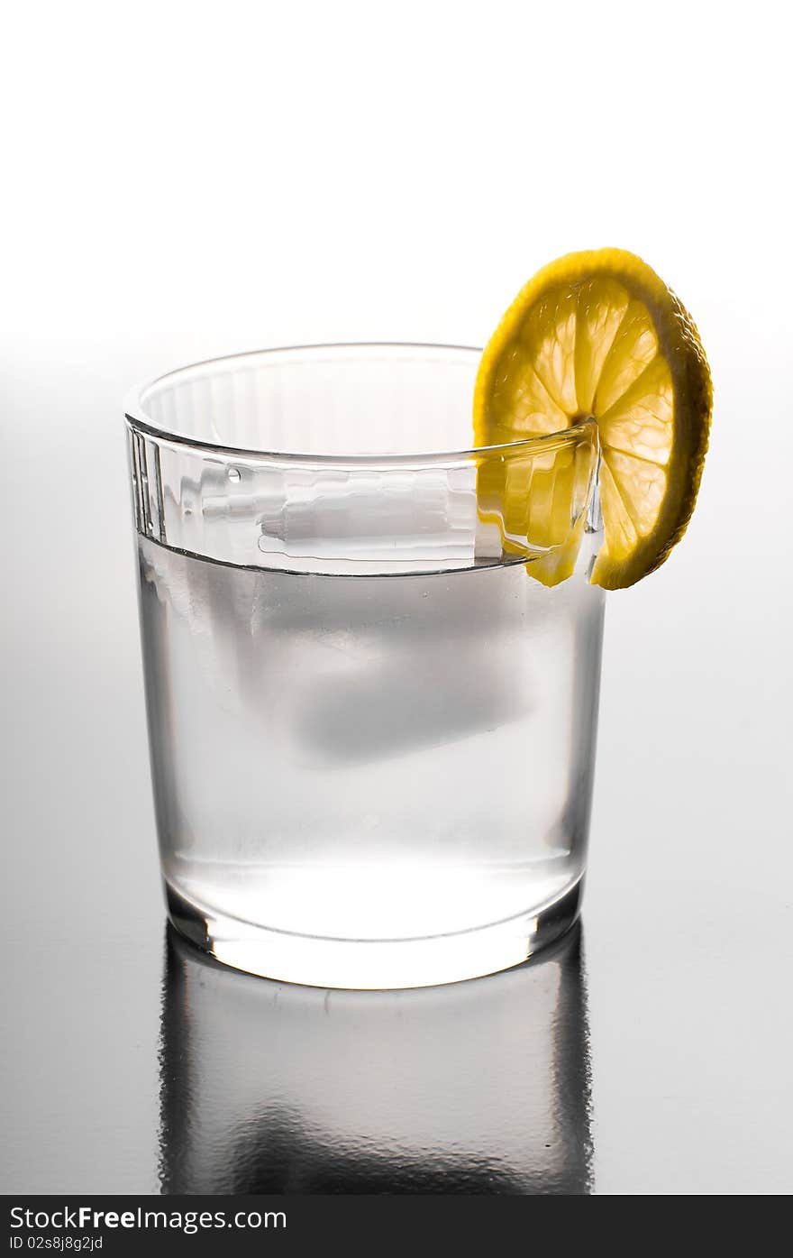 Glass of ice water with a lemon slice