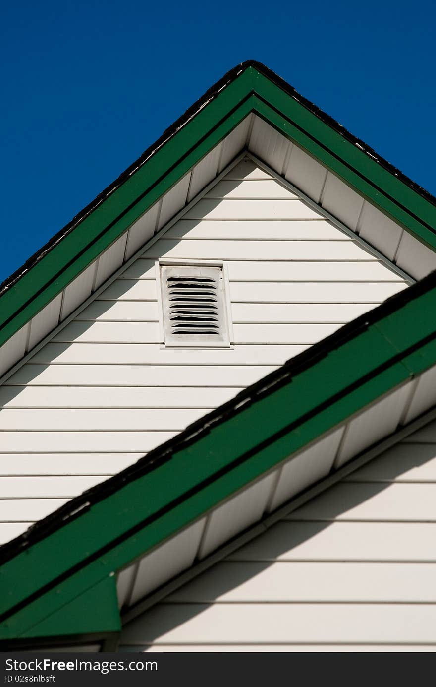 Farmhouse Roof Peak Against A Blue Sky.