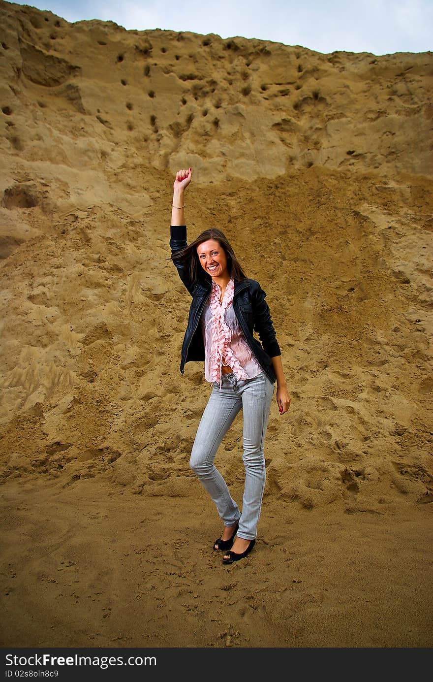 Successful woman with raised her hand with landscape background