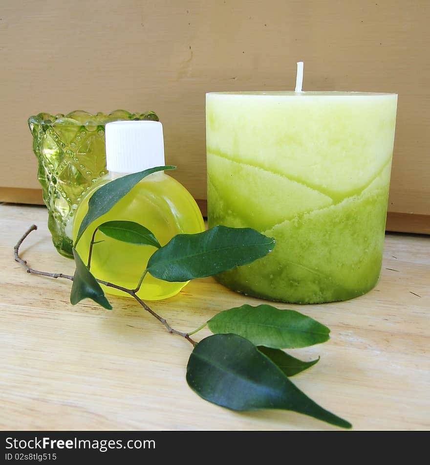 Big candle, soap bottle, leafs and votive candle. Big candle, soap bottle, leafs and votive candle