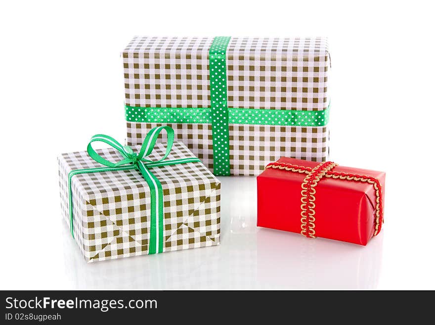 Green checkered presents and a red gift isolated over white. Green checkered presents and a red gift isolated over white