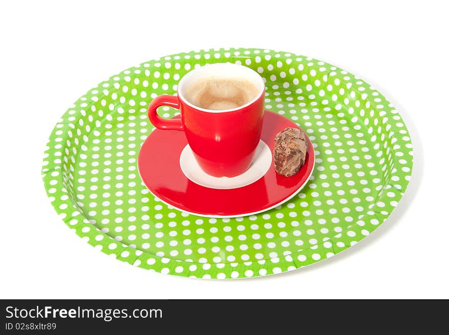 A dotted tray with a cup of coffee and a truffle isolated over white. A dotted tray with a cup of coffee and a truffle isolated over white