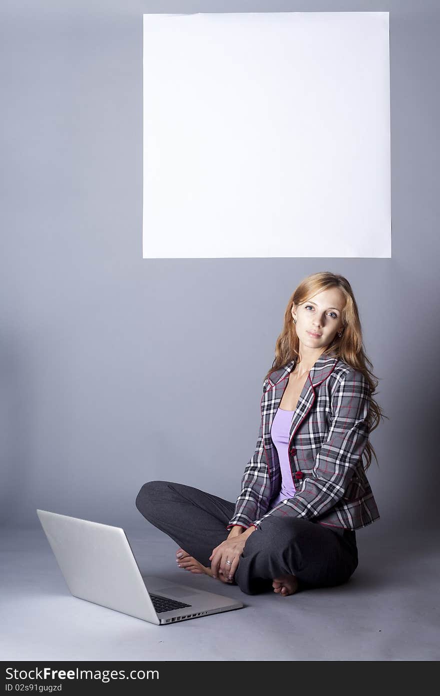 Sitting under a white square. studio photo