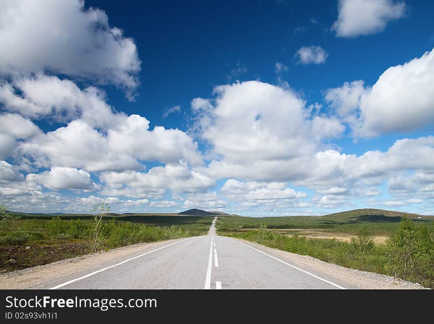 Long road to green hills. Kola Peninsula.