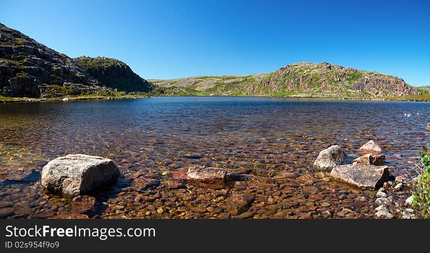 Blue lake idill under cloudy sky