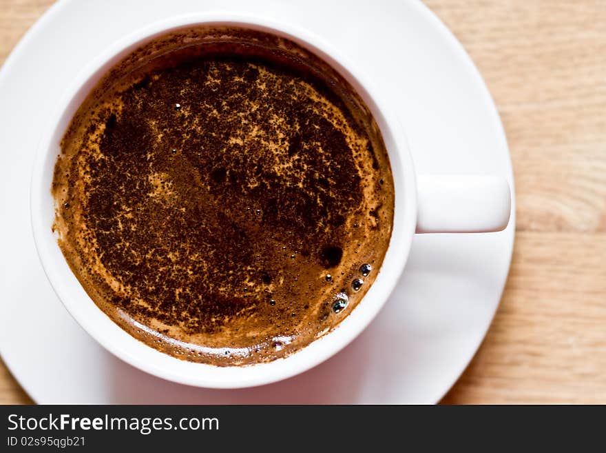 Cup of coffee on the wooden table