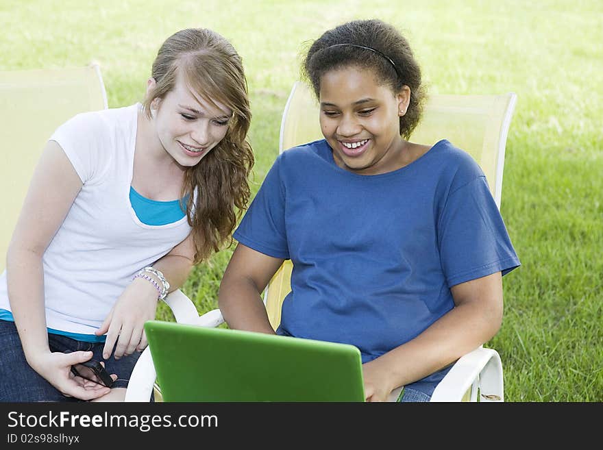 Two girls checking computer