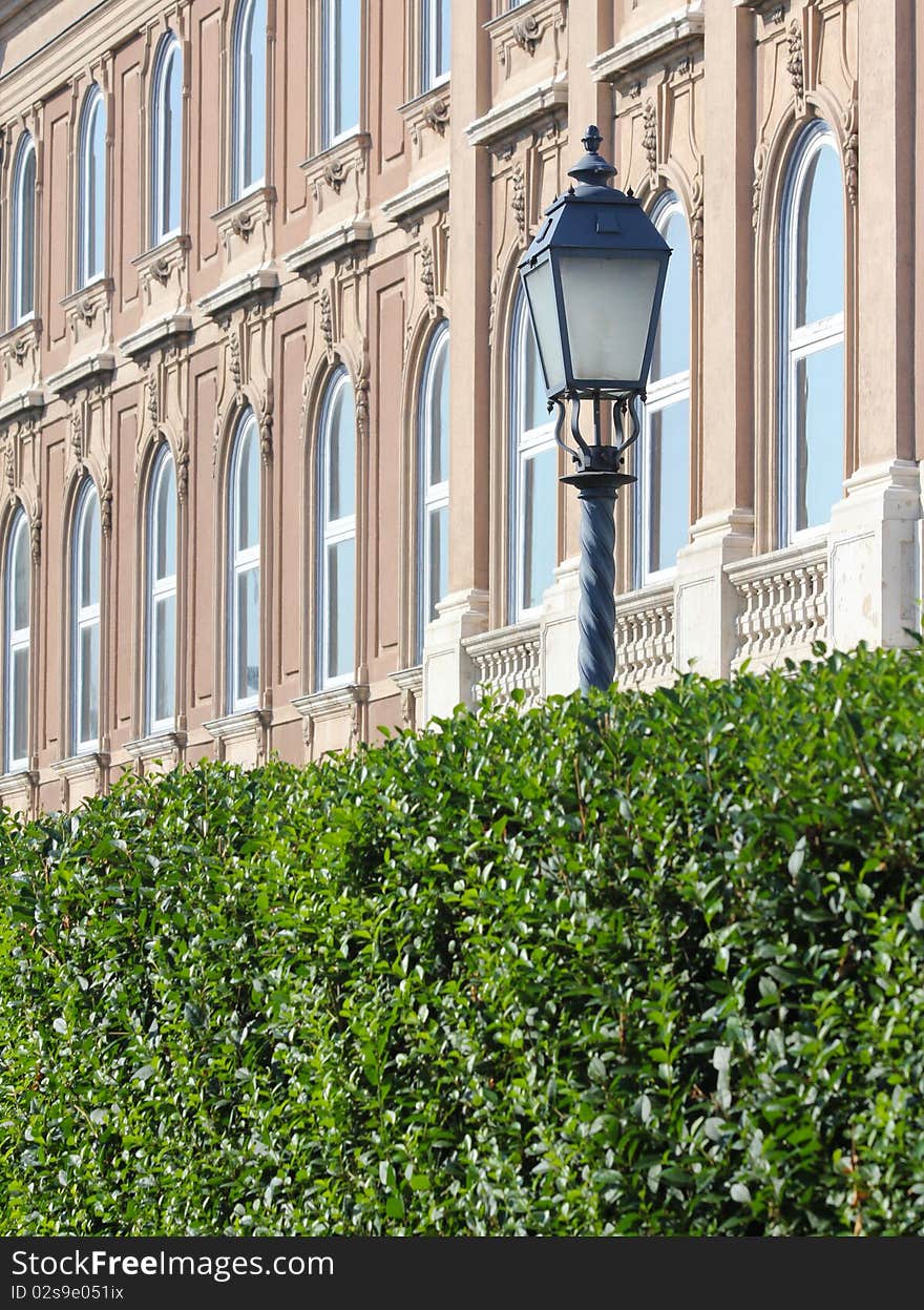 Street lights and building facade details and hedges. Street lights and building facade details and hedges.