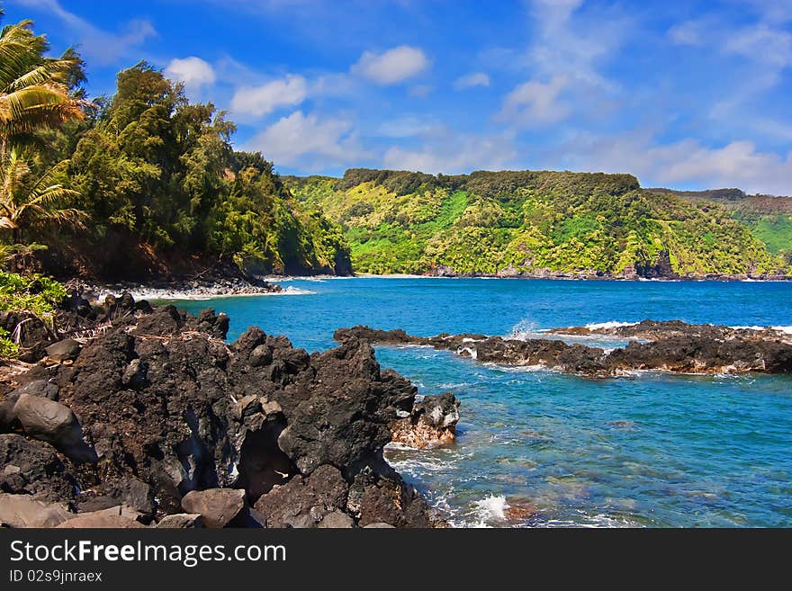 Waves crashing along lava rocks on tropical island. Waves crashing along lava rocks on tropical island.