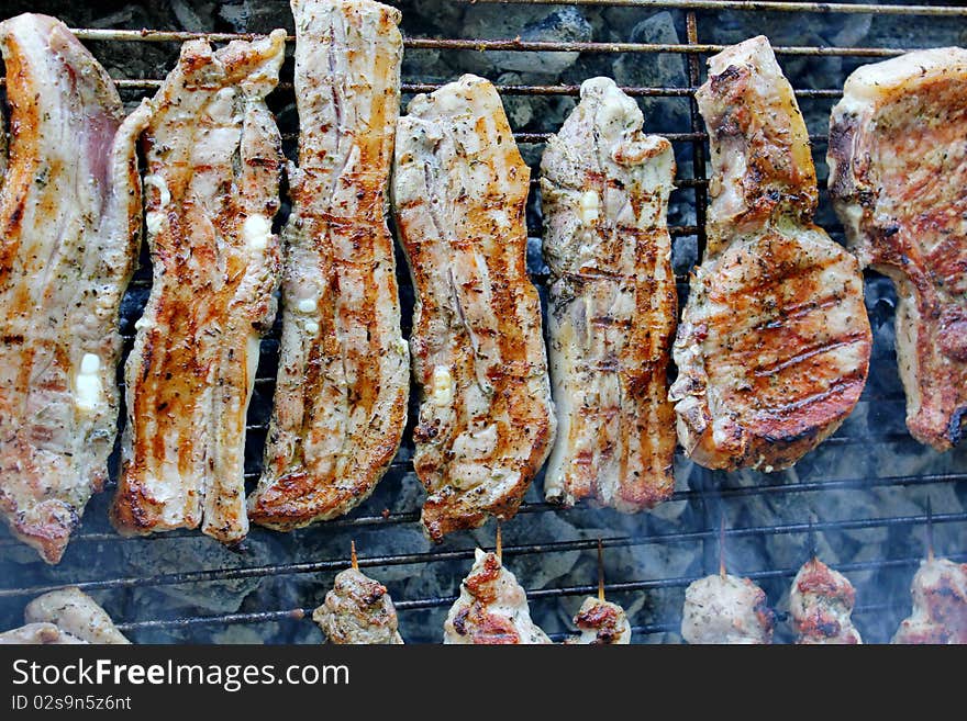 Variety traditional greek grilled meat steaks and chops on rack. Variety traditional greek grilled meat steaks and chops on rack