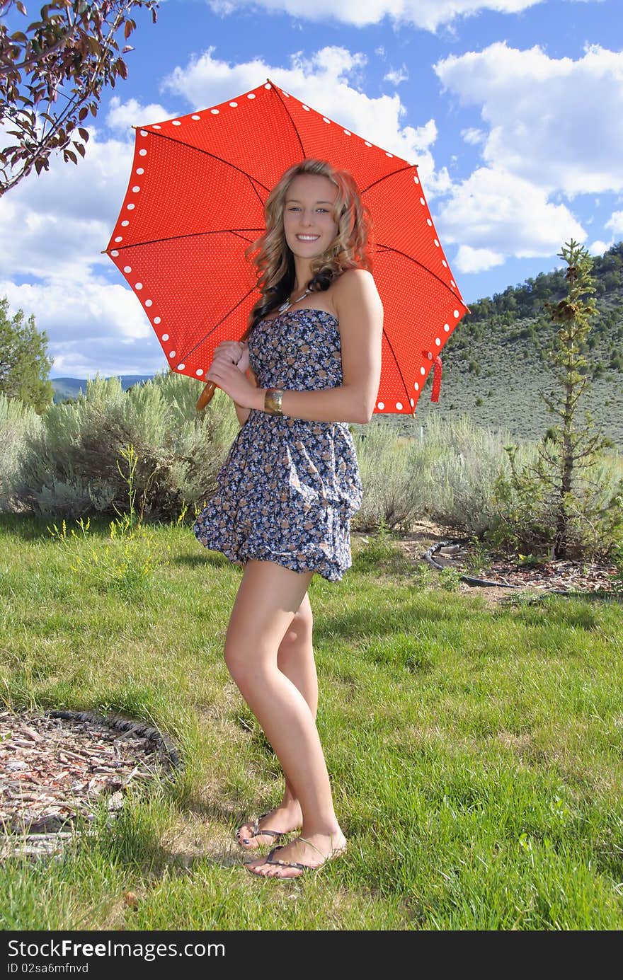 Young teenager with red umbrella in the mountains. Young teenager with red umbrella in the mountains.