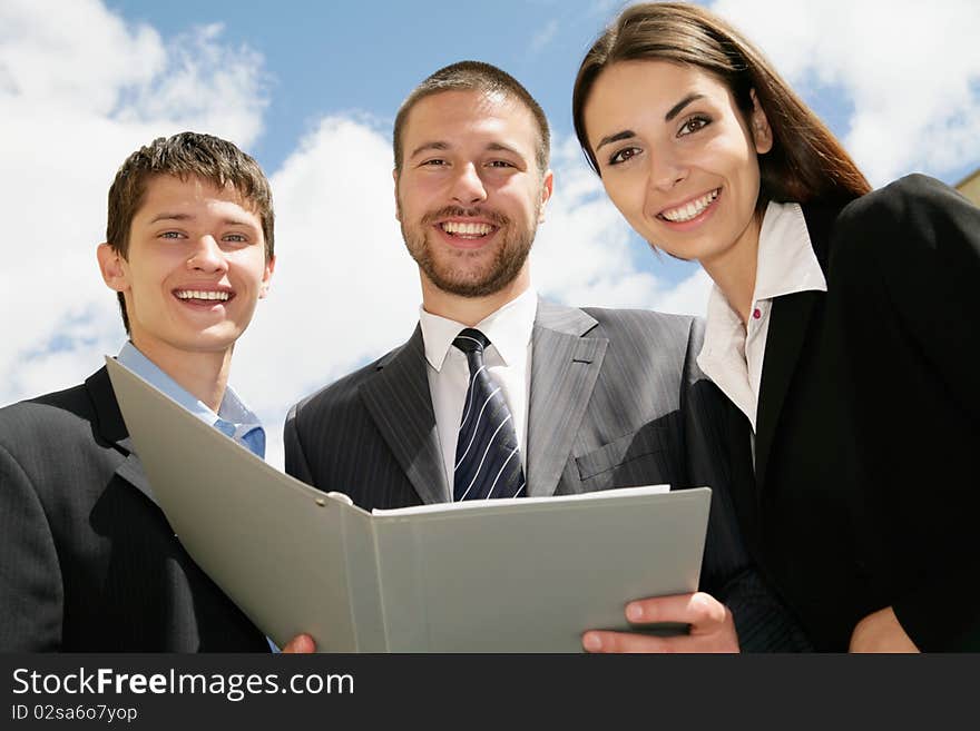 Young and successful businessteam standing in a corridoor of a modern office