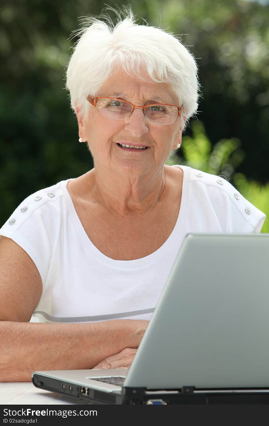 Closeup of elderly woman with laptop computer. Closeup of elderly woman with laptop computer