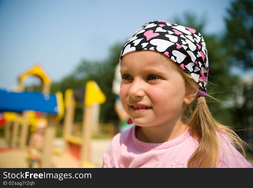 Close-up little girl on outdoor playground equipment