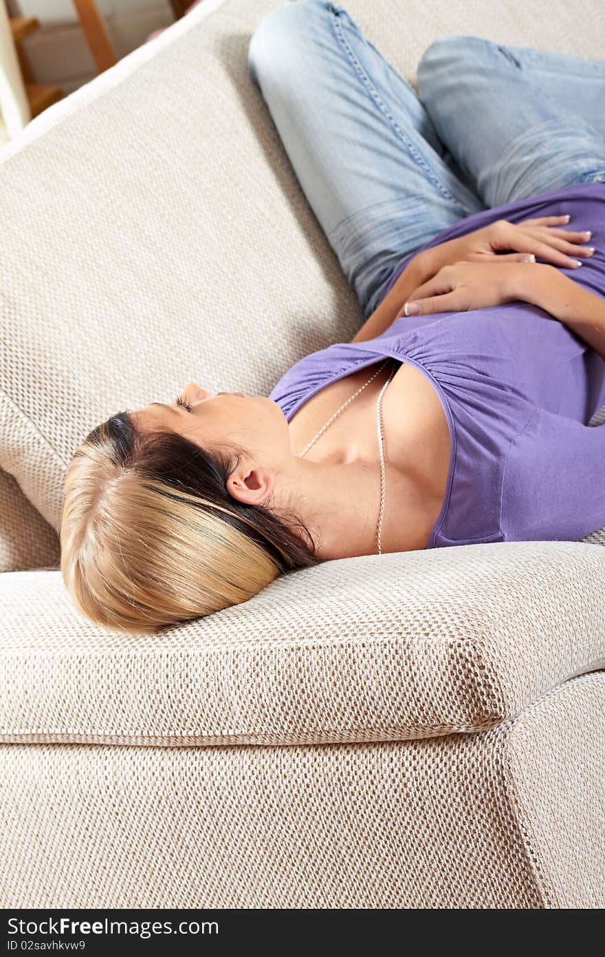 Woman in living room is sleeping on a lounge